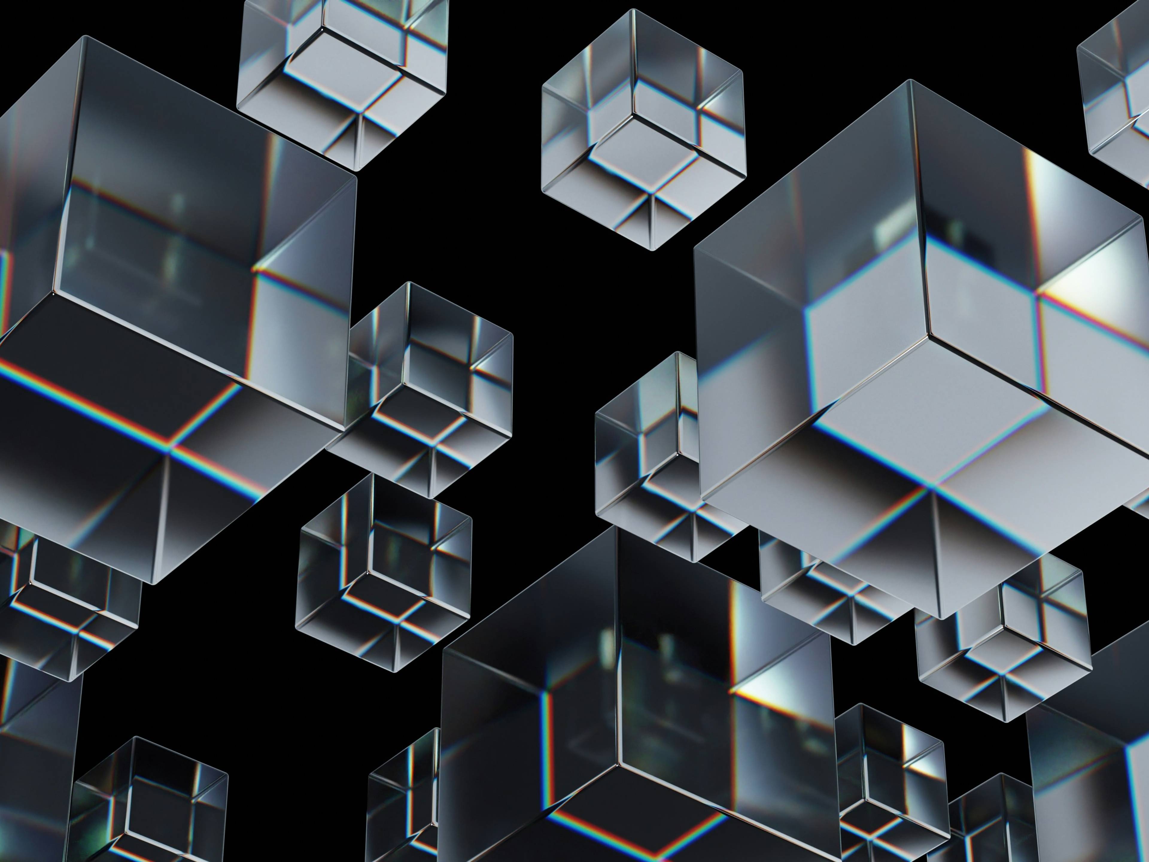 aakash-dhage-en8upg7tuou-unsplash-3792f41e-5cd3-4f31-a519-557a62148535 Una serie de cubos transparentes flotando en un fondo negro.