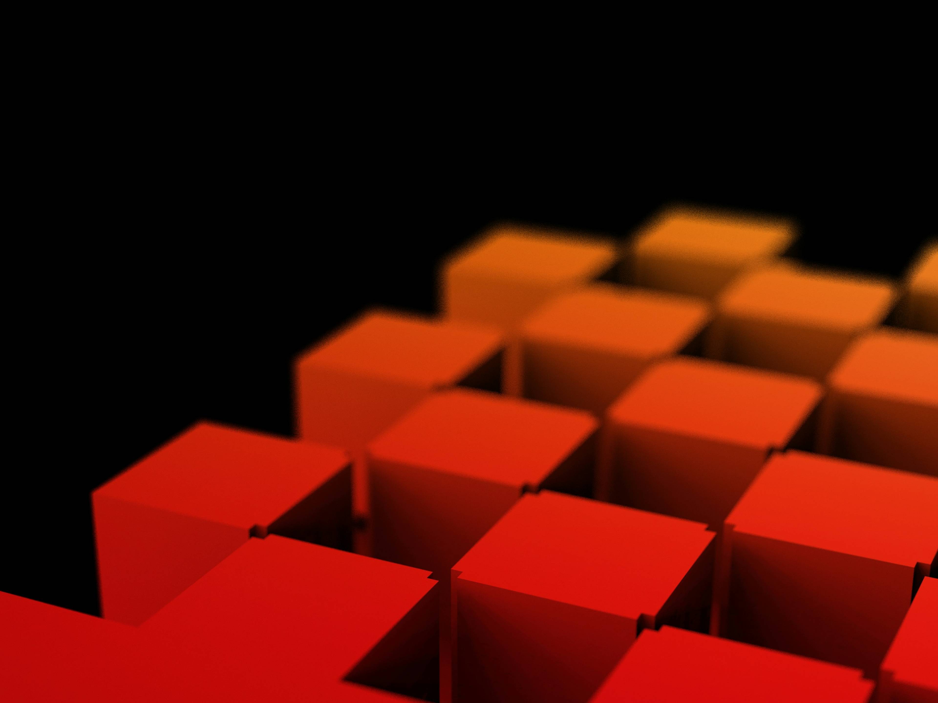 mehdi-mirzaie-sqfetlyhnmw-unsplash-6696d56a-c05b-4dc4-88c0-2f8dbb69ce94 Una serie de bloques en tonos rojos y naranjas sobre un fondo negro.