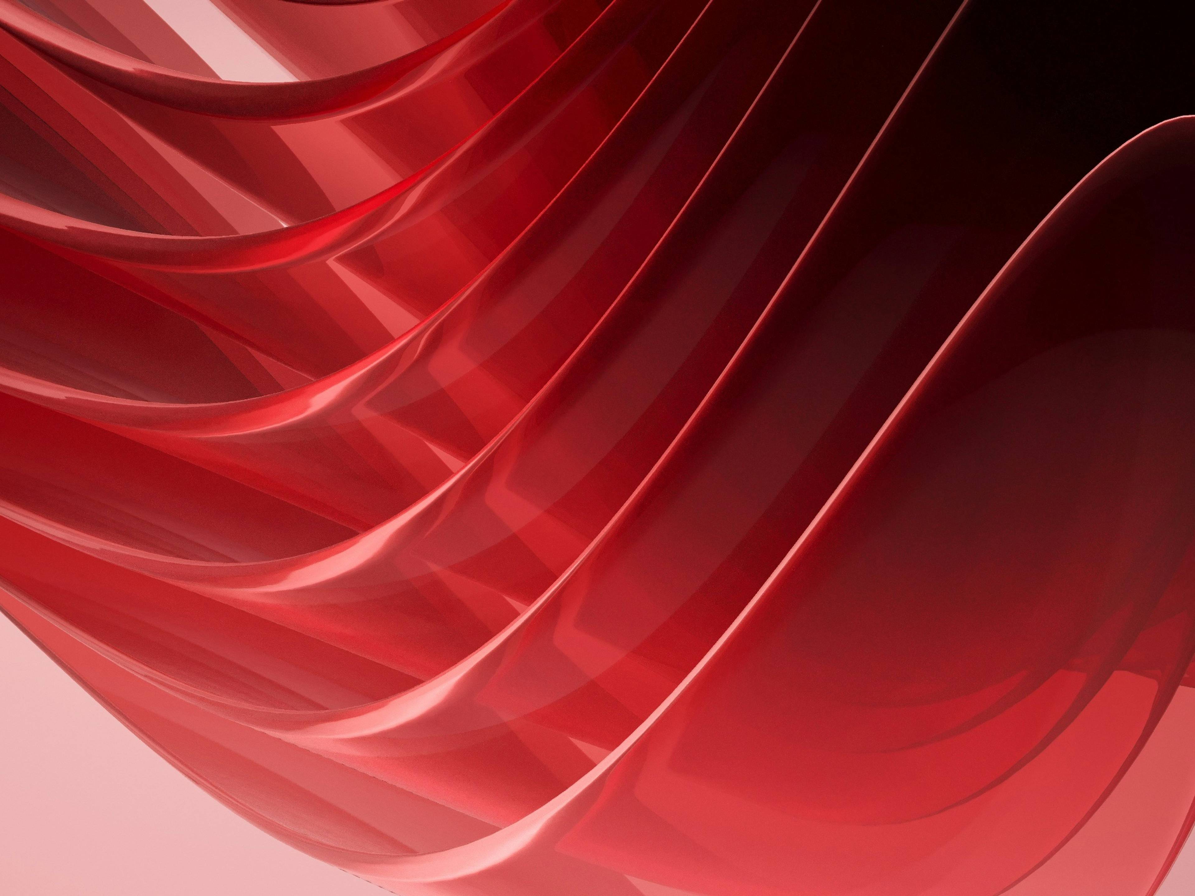 bhautik-patel-5rotzfqu3pm-unsplash-8e1ce51d-50a3-4b41-9d18-7e92ac067a37 La imagen muestra una serie de ondas rojas translúcidas que se entrelazan en un fondo suave.
