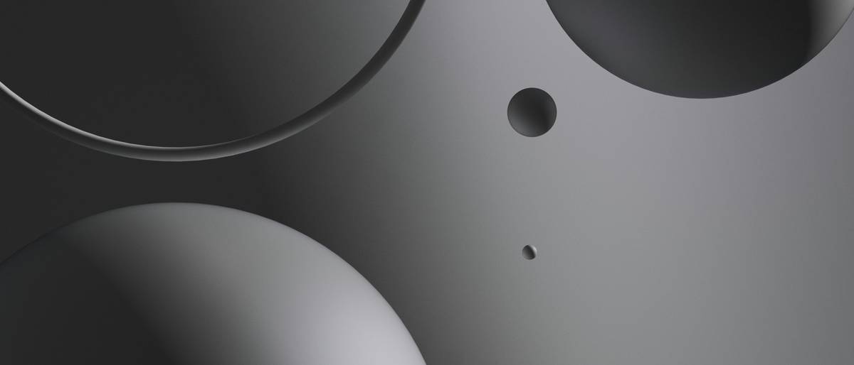 La imagen muestra una composición abstracta de formas esféricas en tonos oscuros.